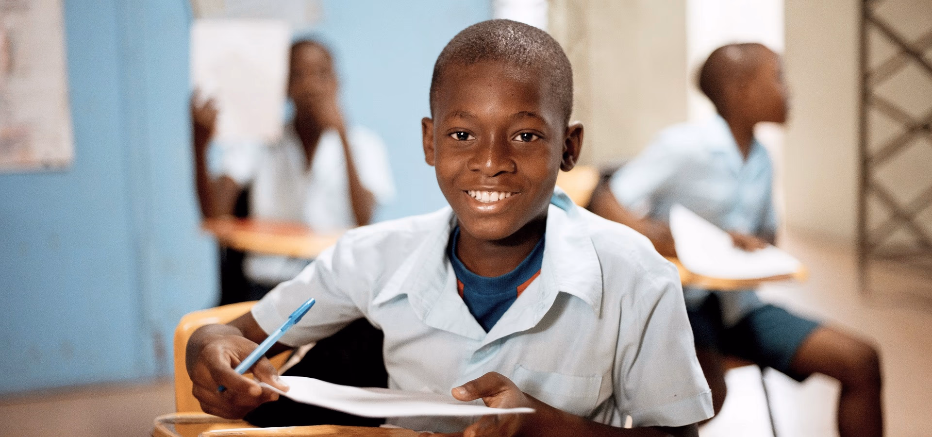 Smiling student at his desk