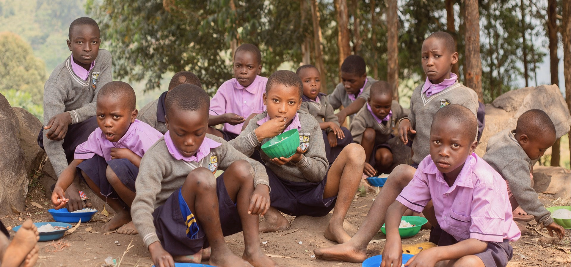 Schoolchildren sitting together outdoors